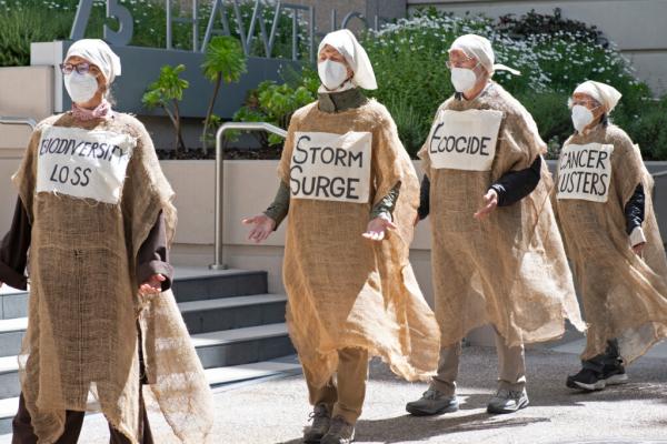 Climate Activists Stage Mock Funeral for…